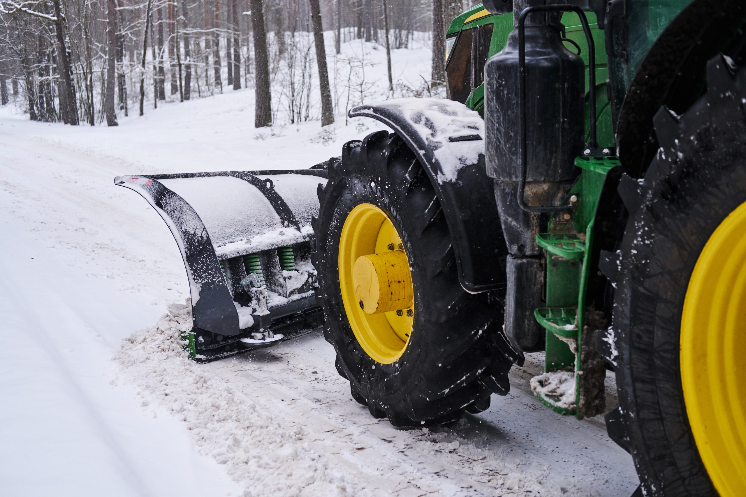 big-special-tractor-is-removing-snow-from-forestal-road